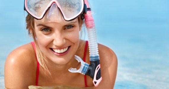 cute-happy-woman-wears-snorking-mask-swimms-swimming-pool-poses-pure-blue-water-has-positive-smile-involved-active-lifestyle-sporty-woman-snorkels-water-water-activities_273609-3253